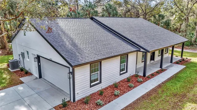 a aerial view of a house with table and chairs