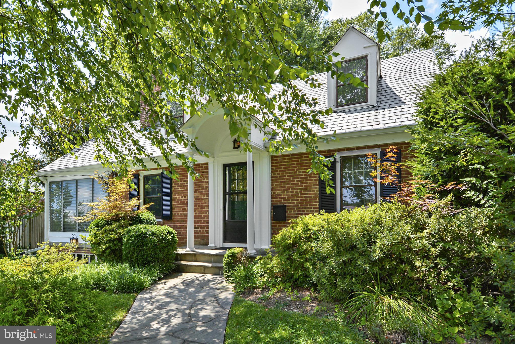 front view of a house with a tree
