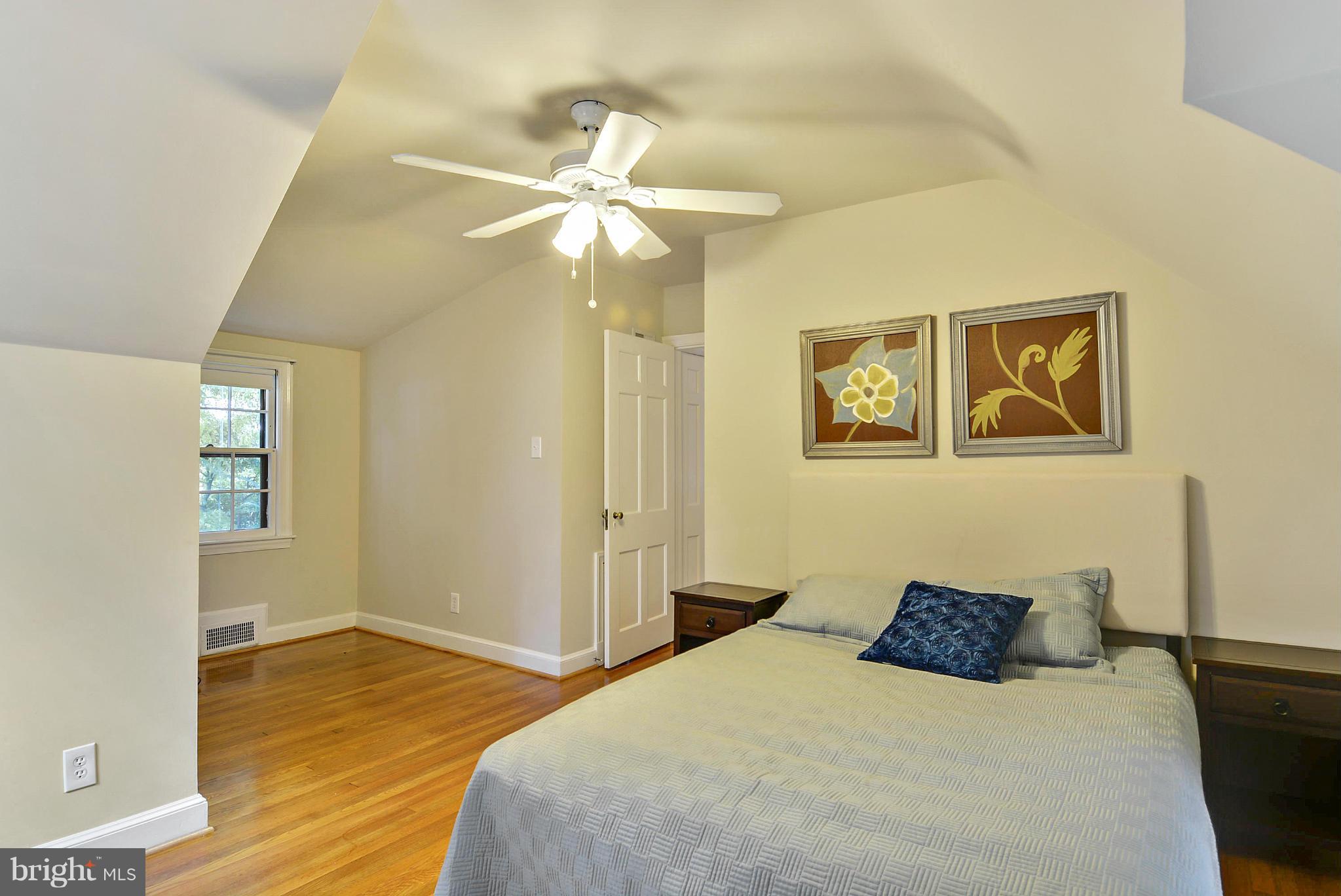 619 Greenbrier Drive Silver Spring, MD 20910 - Photo 17 of 30 a bedroom with a bed and wooden floor