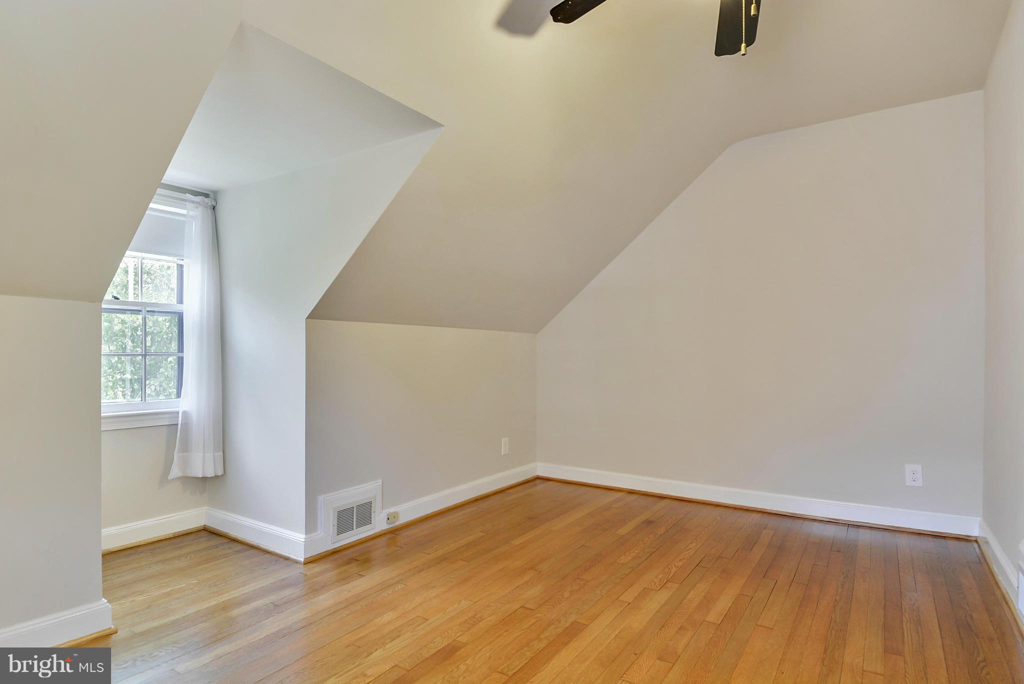 619 Greenbrier Drive Silver Spring, MD 20910 - Photo 21 of 30 an empty room with wooden floor and windows