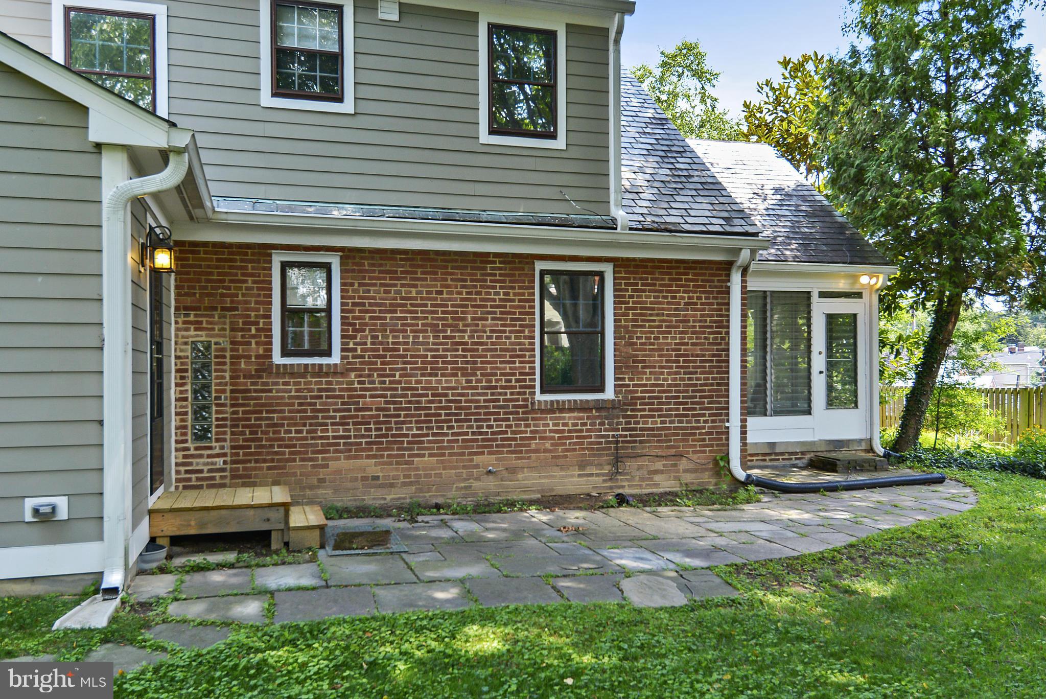 619 Greenbrier Drive Silver Spring, MD 20910 - Photo 28 of 30 a brick house with a yard and table and chairs in a yard
