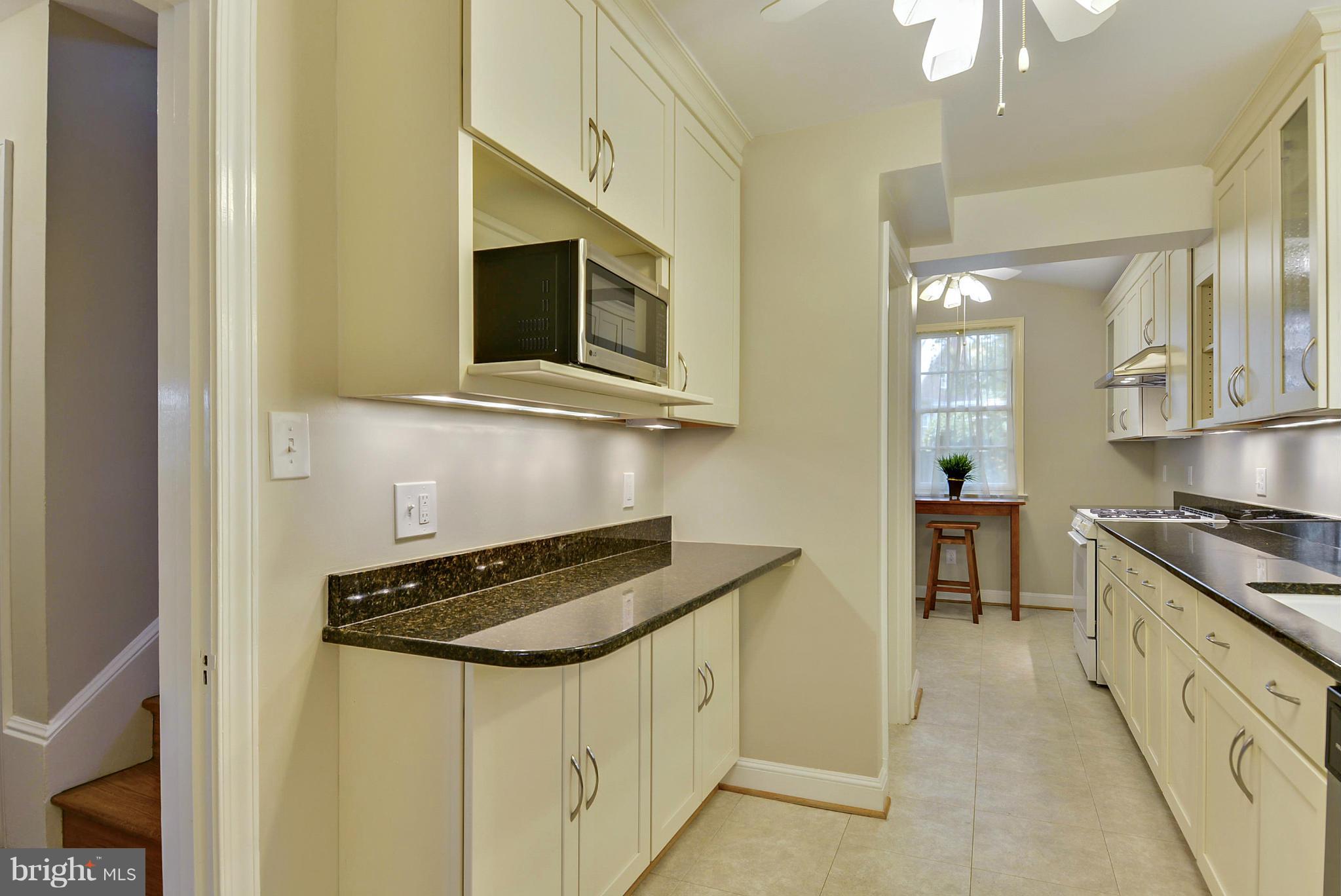 619 Greenbrier Drive Silver Spring, MD 20910 - Photo 8 of 30 a kitchen with stainless steel appliances a sink stove and cabinets