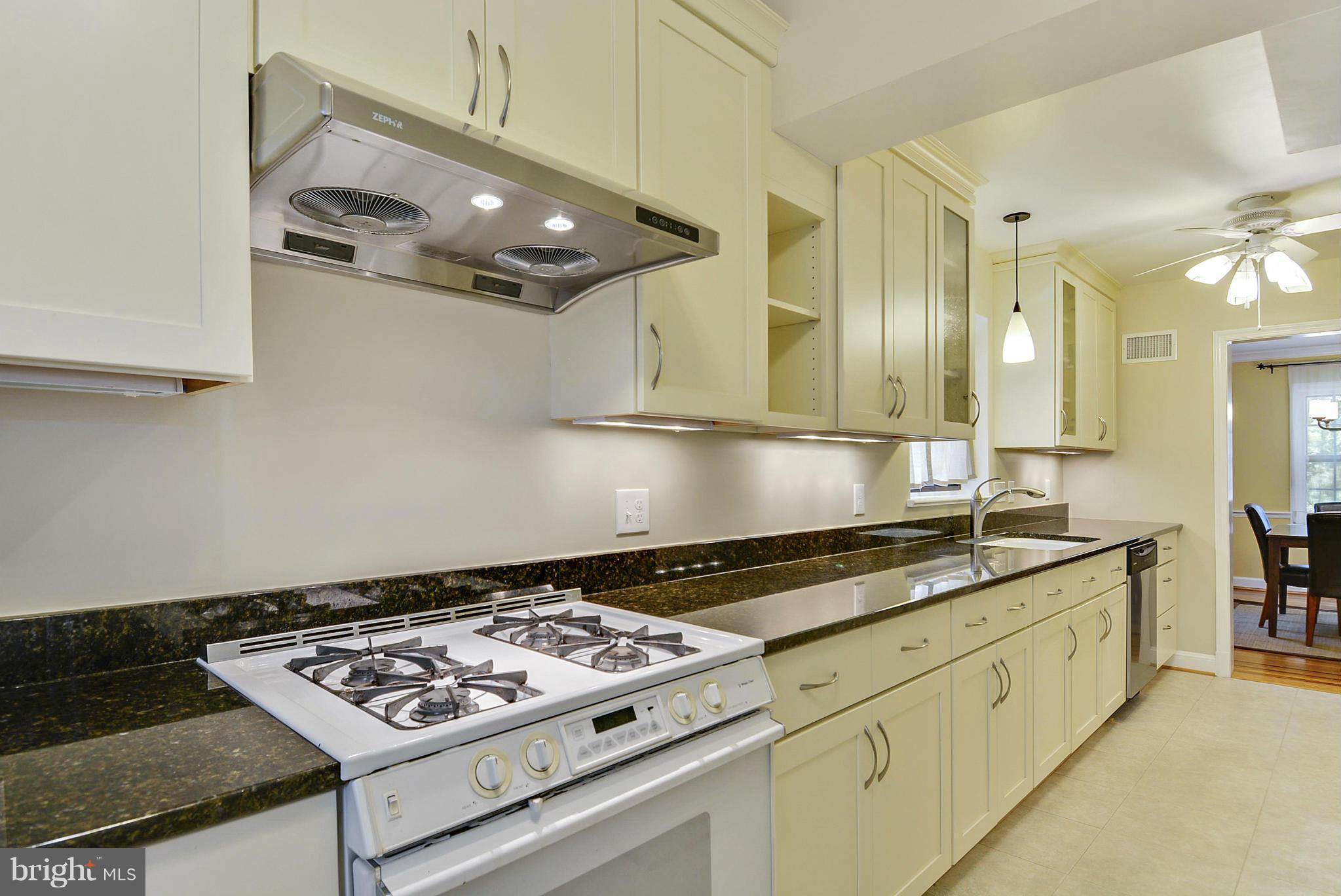 619 Greenbrier Drive Silver Spring, MD 20910 - Photo 10 of 30 a kitchen with stainless steel appliances granite countertop a stove and a sink