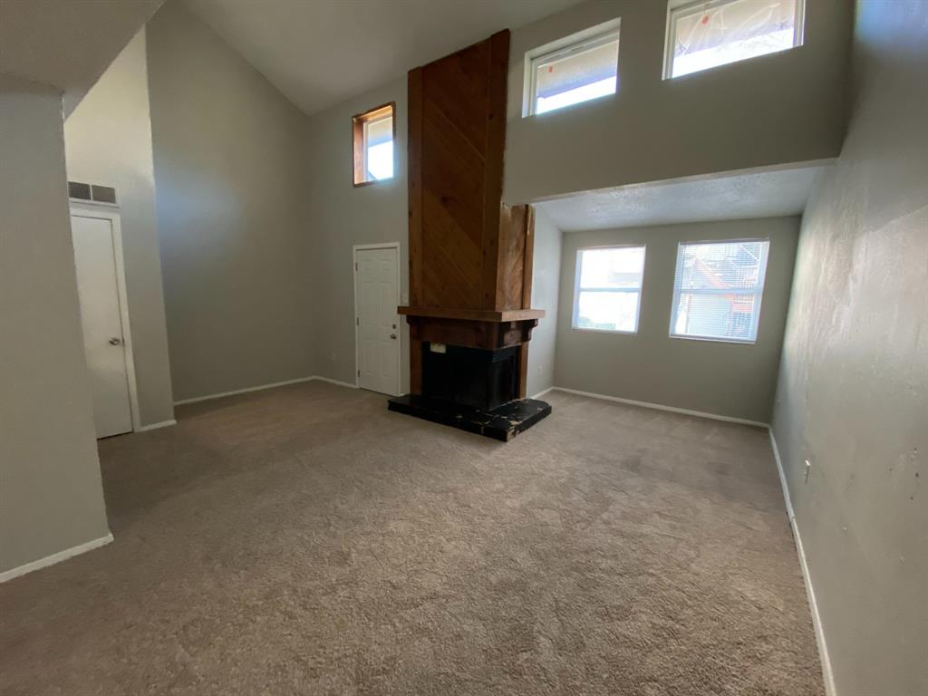 9696 Walnut Street, Unit 708 Dallas, TX 75243 - Photo 2 of 10 an empty room with windows and fireplace