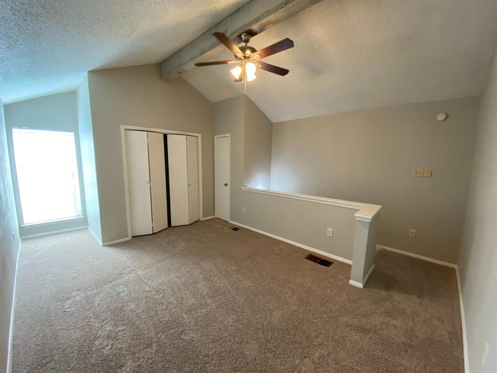 9696 Walnut Street, Unit 708 Dallas, TX 75243 - Photo 6 of 10 an empty room with closet and a ceiling fan