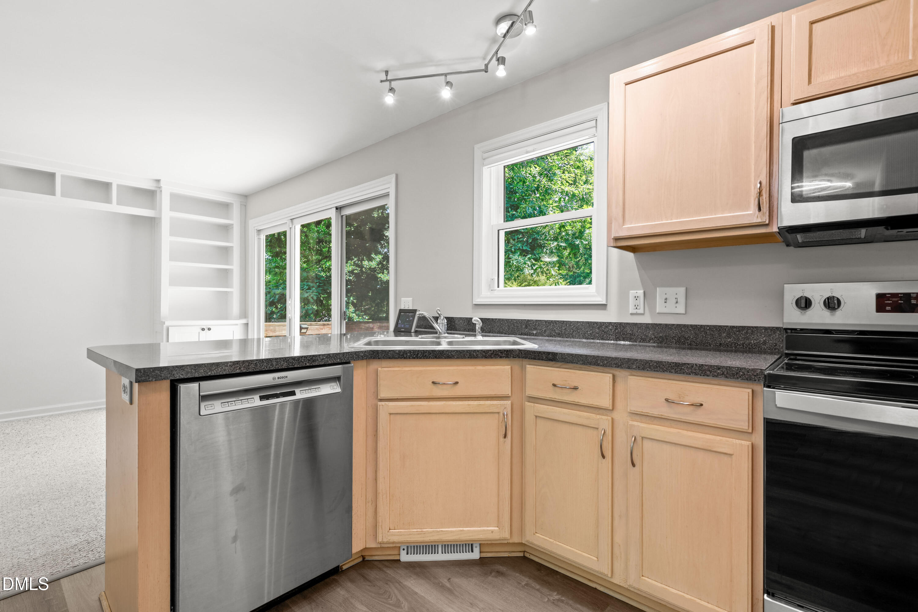3015 Rennit Court Raleigh, NC 27603 - Photo 11 of 40 a kitchen with granite countertop white cabinets window and sink