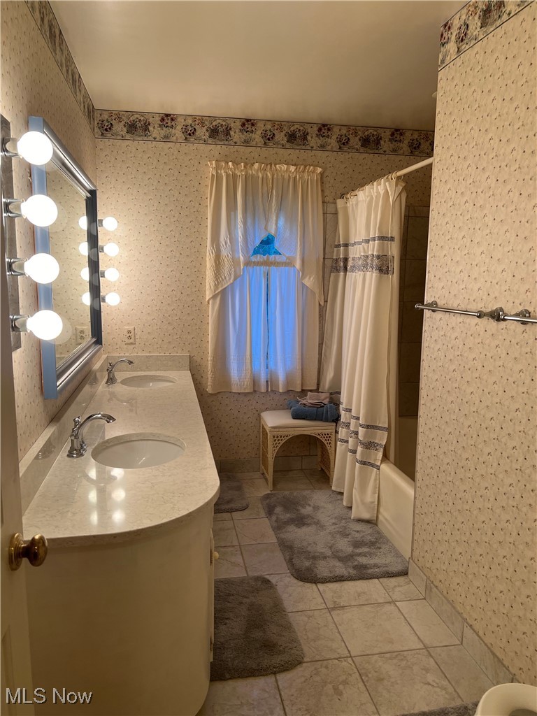 3330 Stanley Road Akron, OH 44333 - Photo 17 of 22 Bathroom featuring tile patterned floors, vanity, and shower / tub combo