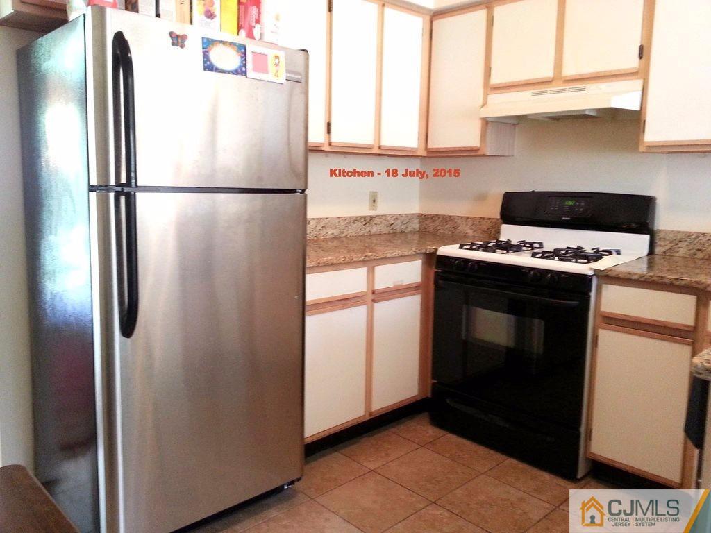 218 Nebula Road Piscataway, NJ 08854 - Photo 3 of 15 a white refrigerator freezer and a stove sitting inside of a kitchen