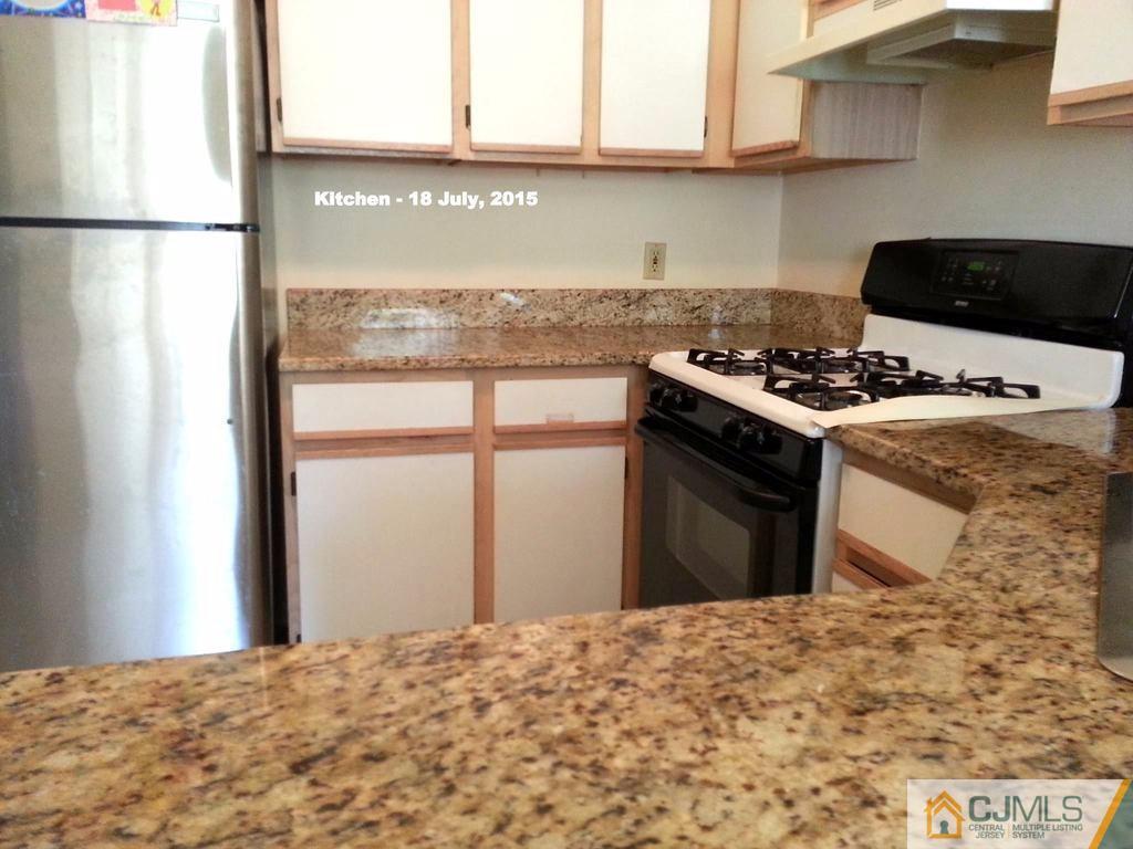218 Nebula Road Piscataway, NJ 08854 - Photo 4 of 15 a kitchen with a stove and a refrigerator