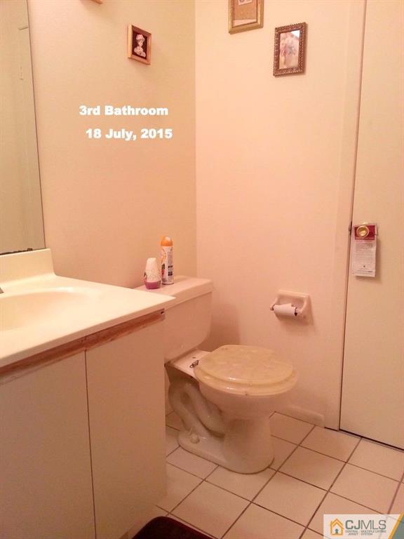 218 Nebula Road Piscataway, NJ 08854 - Photo 9 of 15 a bathroom with a sink a toilet and mirror
