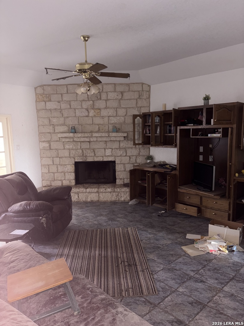 10520 Highway 281 Spring Branch, TX 78070 - Photo 4 of 11 a living room with furniture a flat screen tv and fireplace