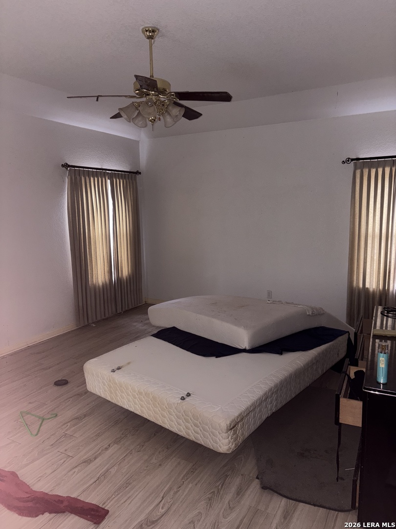 10520 Highway 281 Spring Branch, TX 78070 - Photo 9 of 11 a bedroom with a bed and a chandelier