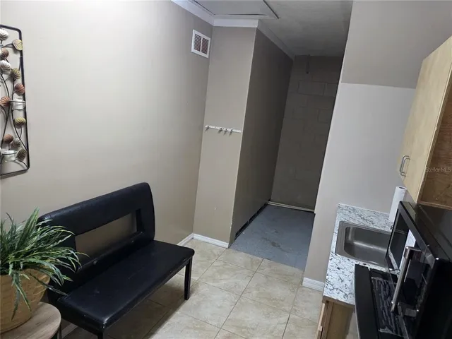 a living room with furniture and a potted plant