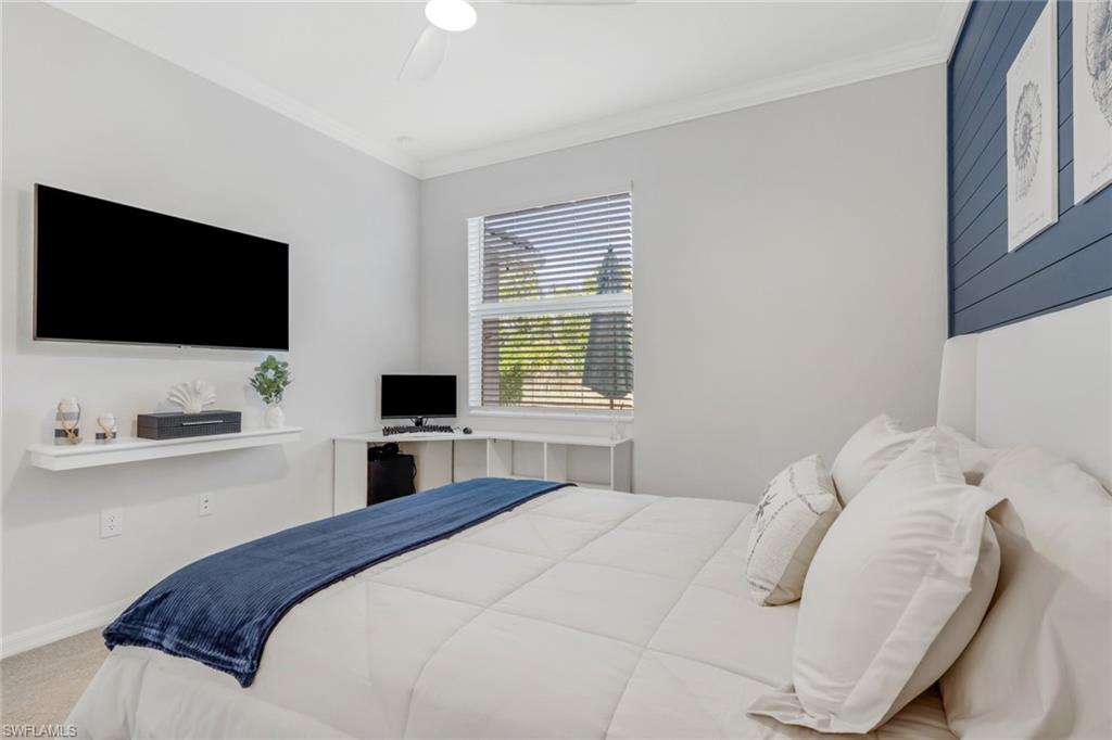 2187 Cara Cara Way Naples, FL 34120 - Photo 15 of 50 Bedroom with crown molding, a ceiling fan, and carpet flooring