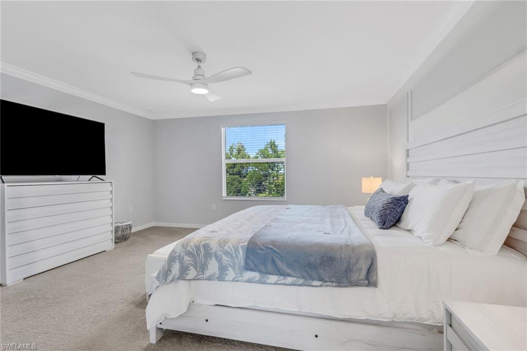 2187 Cara Cara Way Naples, FL 34120 - Photo 19 of 50 Carpeted bedroom with a ceiling fan and ornamental molding