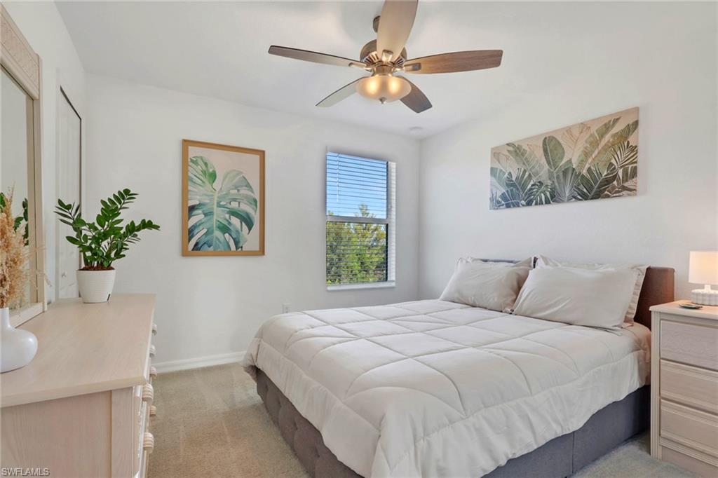 2187 Cara Cara Way Naples, FL 34120 - Photo 22 of 50 Bedroom featuring light carpet and ceiling fan