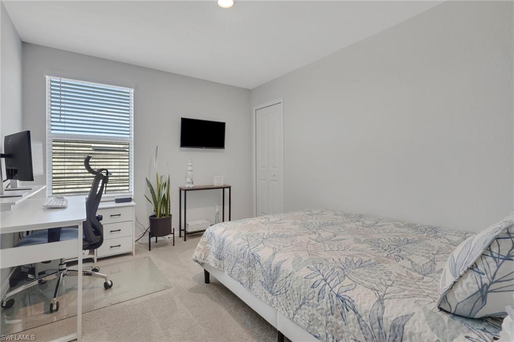 2187 Cara Cara Way Naples, FL 34120 - Photo 24 of 50 Bedroom with a desk and light colored carpet