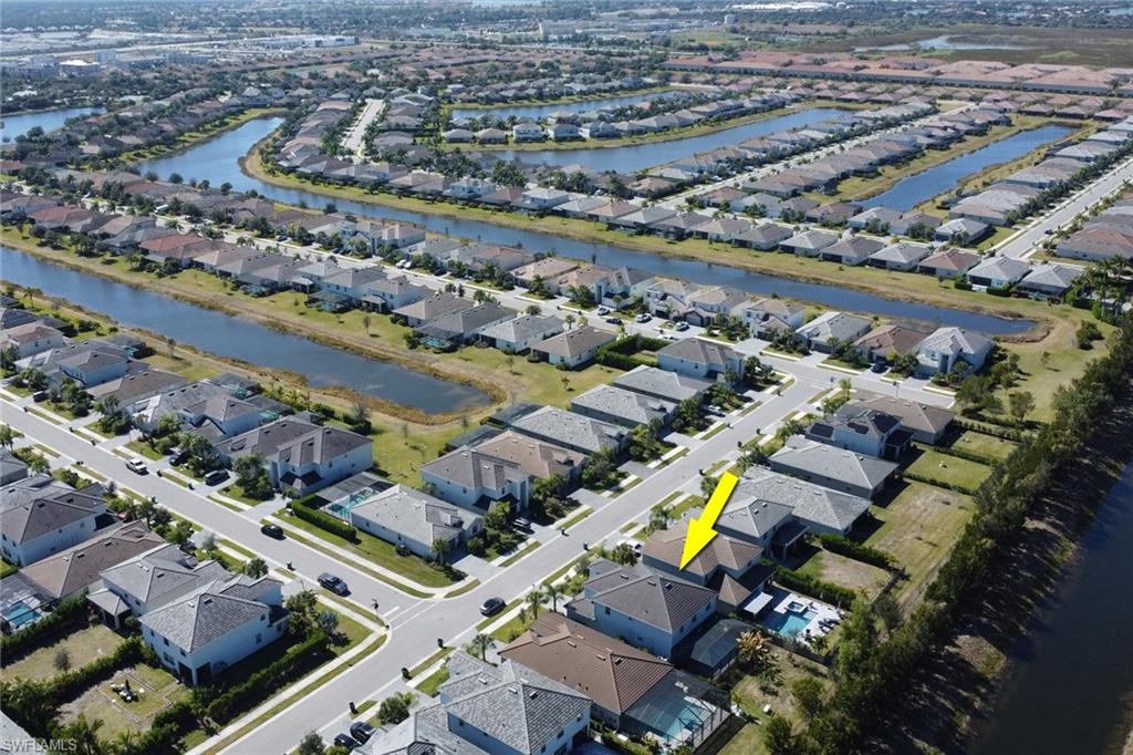 2187 Cara Cara Way Naples, FL 34120 - Photo 32 of 50 Aerial overview of property's location featuring a large body of water and nearby suburban area