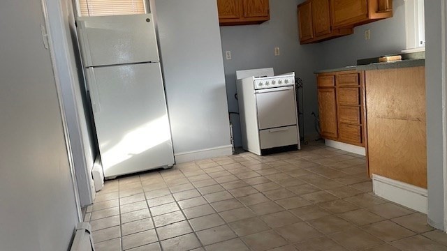 58 Federal Avenue, Unit 2 Quincy, MA 02169 - Photo 1 of 10 a view of empty room with a refrigerator and washer