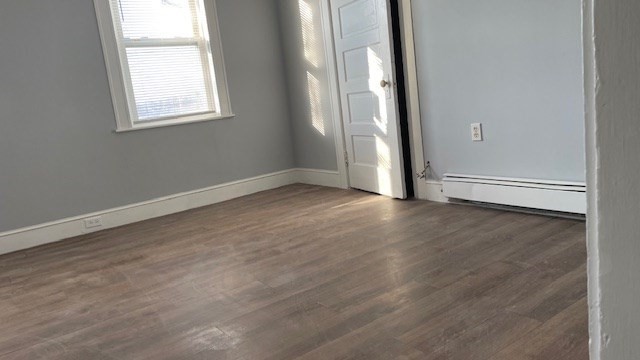 58 Federal Avenue, Unit 2 Quincy, MA 02169 - Photo 5 of 10 an empty room with wooden floor and windows