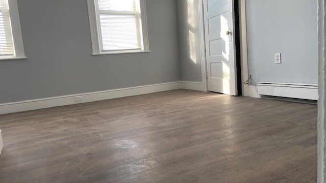 58 Federal Avenue, Unit 2 Quincy, MA 02169 - Photo 6 of 10 an empty room with windows