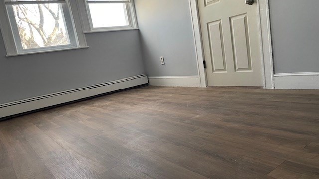 58 Federal Avenue, Unit 2 Quincy, MA 02169 - Photo 8 of 10 an empty room with wooden floor and windows