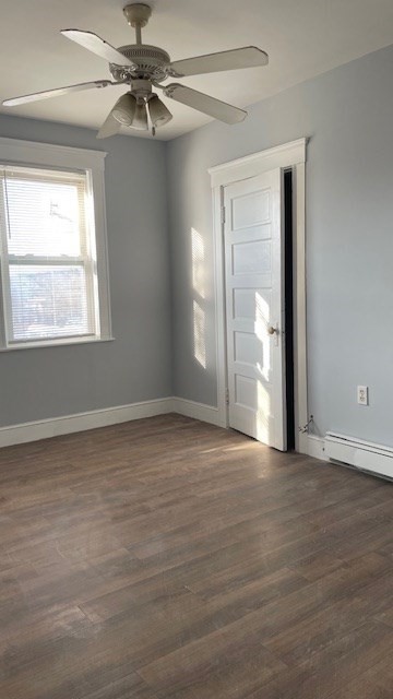 58 Federal Avenue, Unit 2 Quincy, MA 02169 - Photo 9 of 10 a view of an empty room with window and chandelier fan