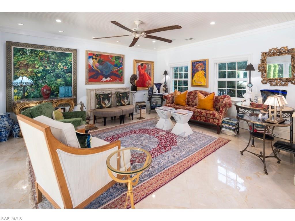 247 6th Street North Naples, FL 34102 - Photo 11 of 30 a living room with furniture a rug and a large window