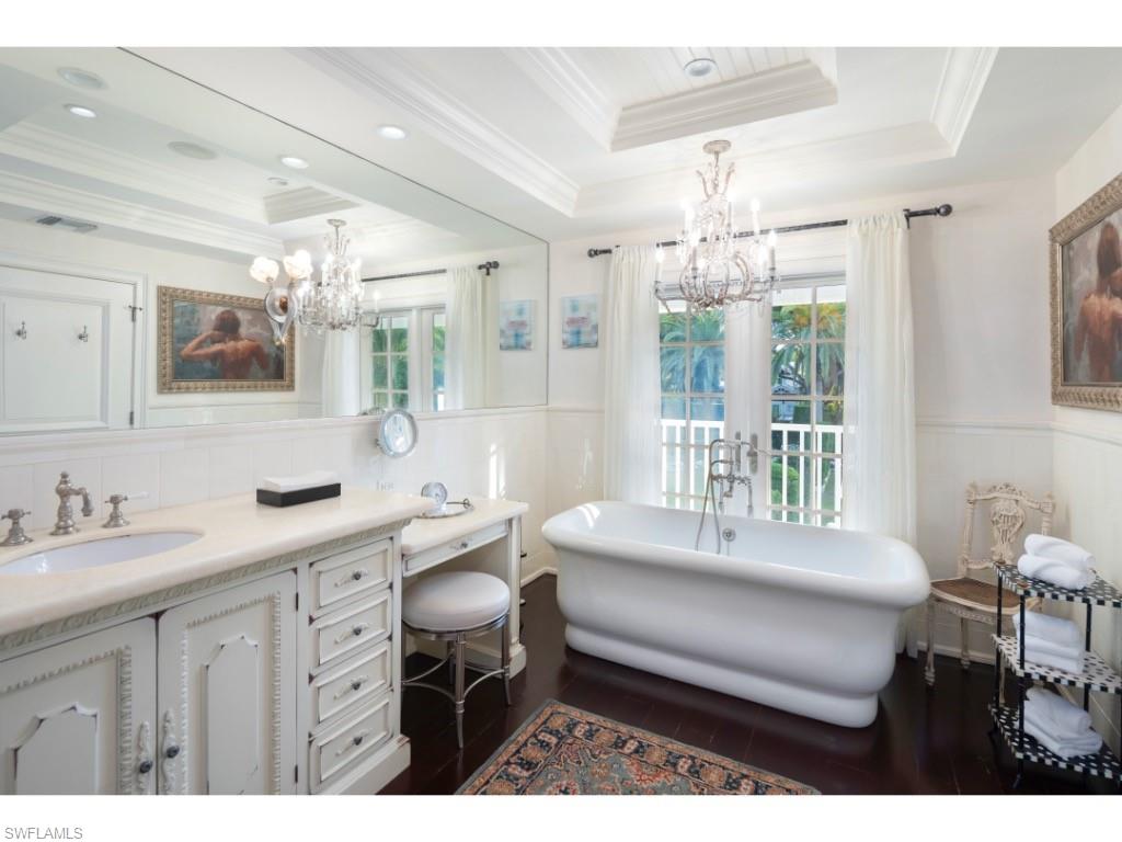 247 6th Street North Naples, FL 34102 - Photo 16 of 30 a bedroom with a bed window and table