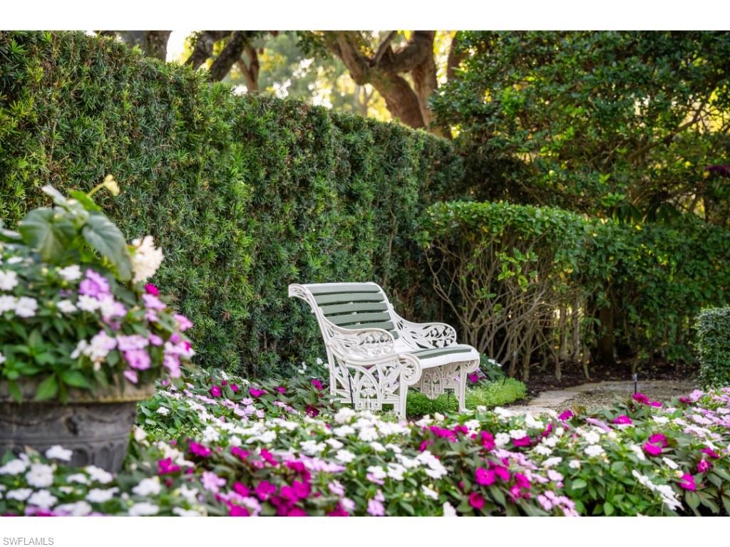 247 6th Street North Naples, FL 34102 - Photo 28 of 30 a view of a flower in a garden with sitting area