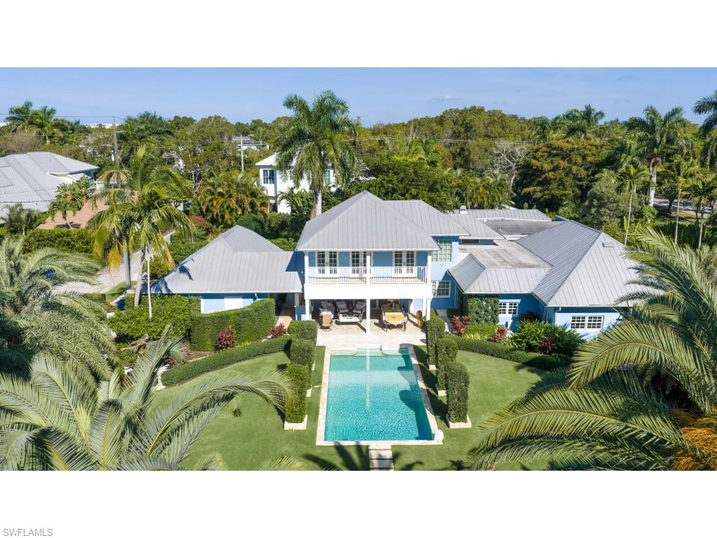247 6th Street North Naples, FL 34102 - Photo 5 of 30 a backyard of a house with wooden floor and outdoor seating