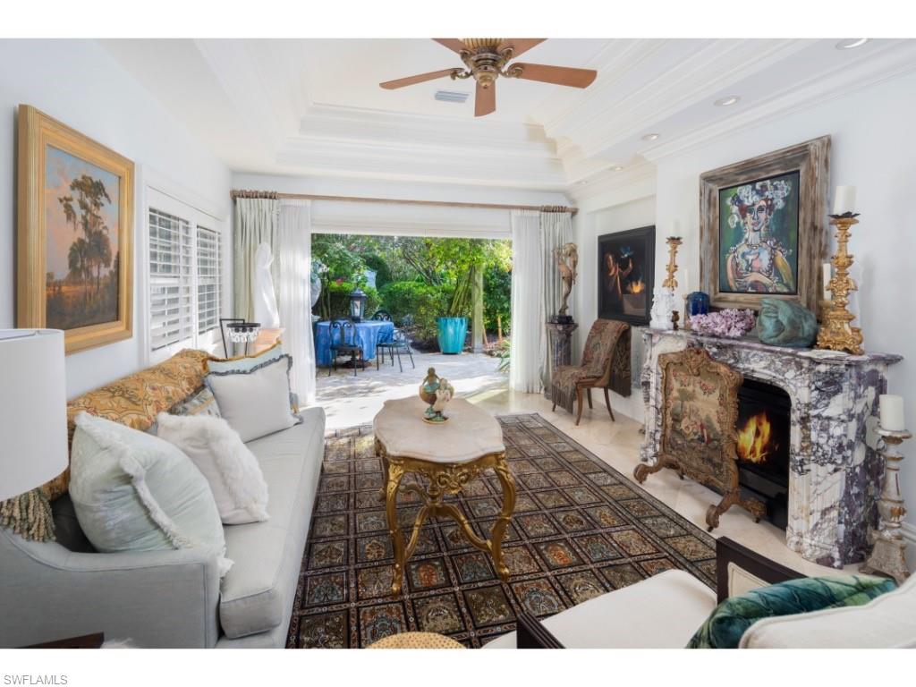 247 6th Street North Naples, FL 34102 - Photo 9 of 30 a living room with furniture and a fireplace