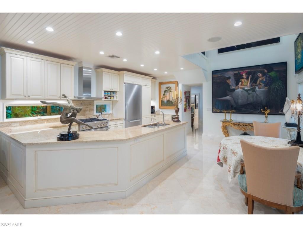 247 6th Street North Naples, FL 34102 - Photo 10 of 30 a living room with stainless steel appliances furniture and a flat screen tv