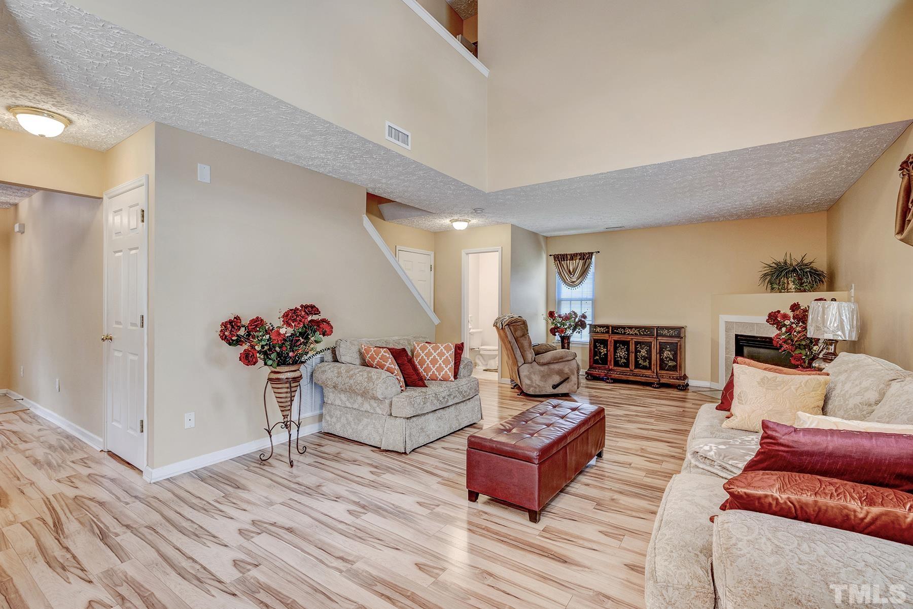 5712 Forest Point Road Raleigh, NC 27610 - Photo 15 of 23 a living room with furniture and a wooden floor
