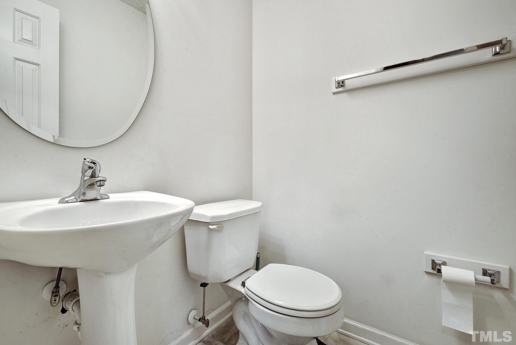 5712 Forest Point Road Raleigh, NC 27610 - Photo 17 of 23 a bathroom with a toilet a sink and a mirror