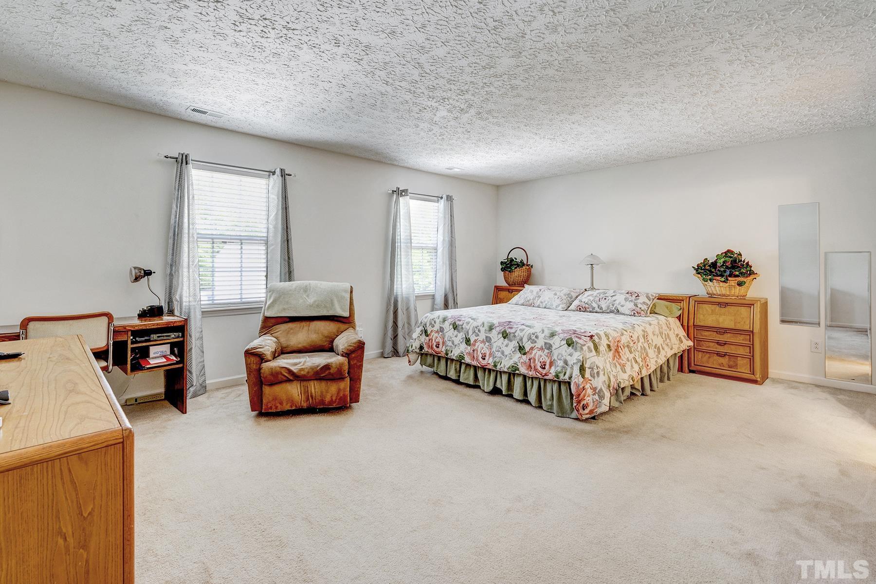 5712 Forest Point Road Raleigh, NC 27610 - Photo 20 of 23 a bedroom with two beds and a couch