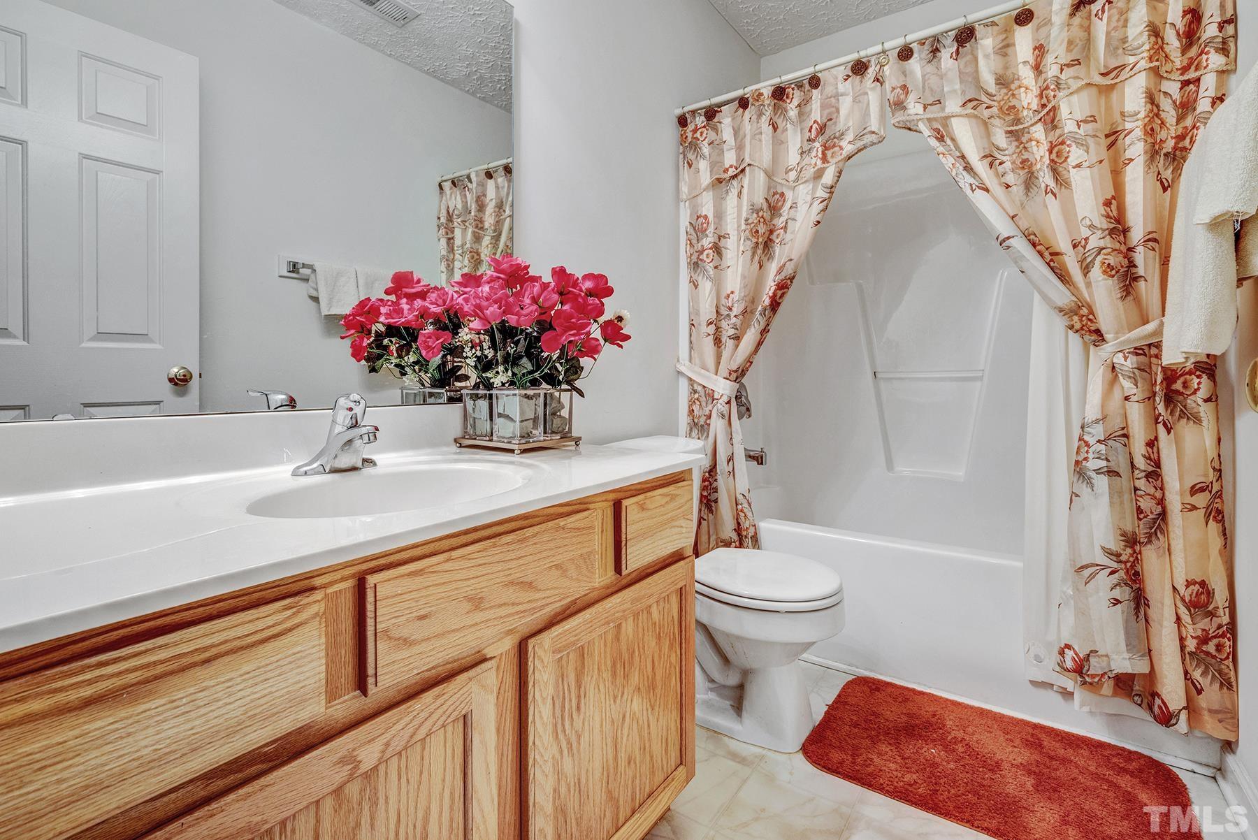 5712 Forest Point Road Raleigh, NC 27610 - Photo 23 of 23 a bathroom with a sink a toilet and shower