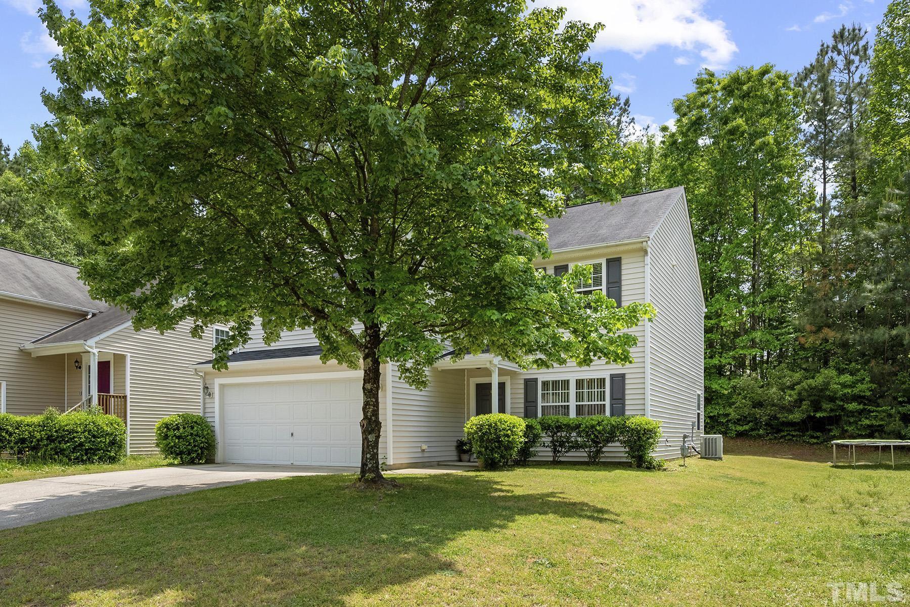 5712 Forest Point Road Raleigh, NC 27610 - Photo 3 of 23 a front view of a house with a yard and a tree