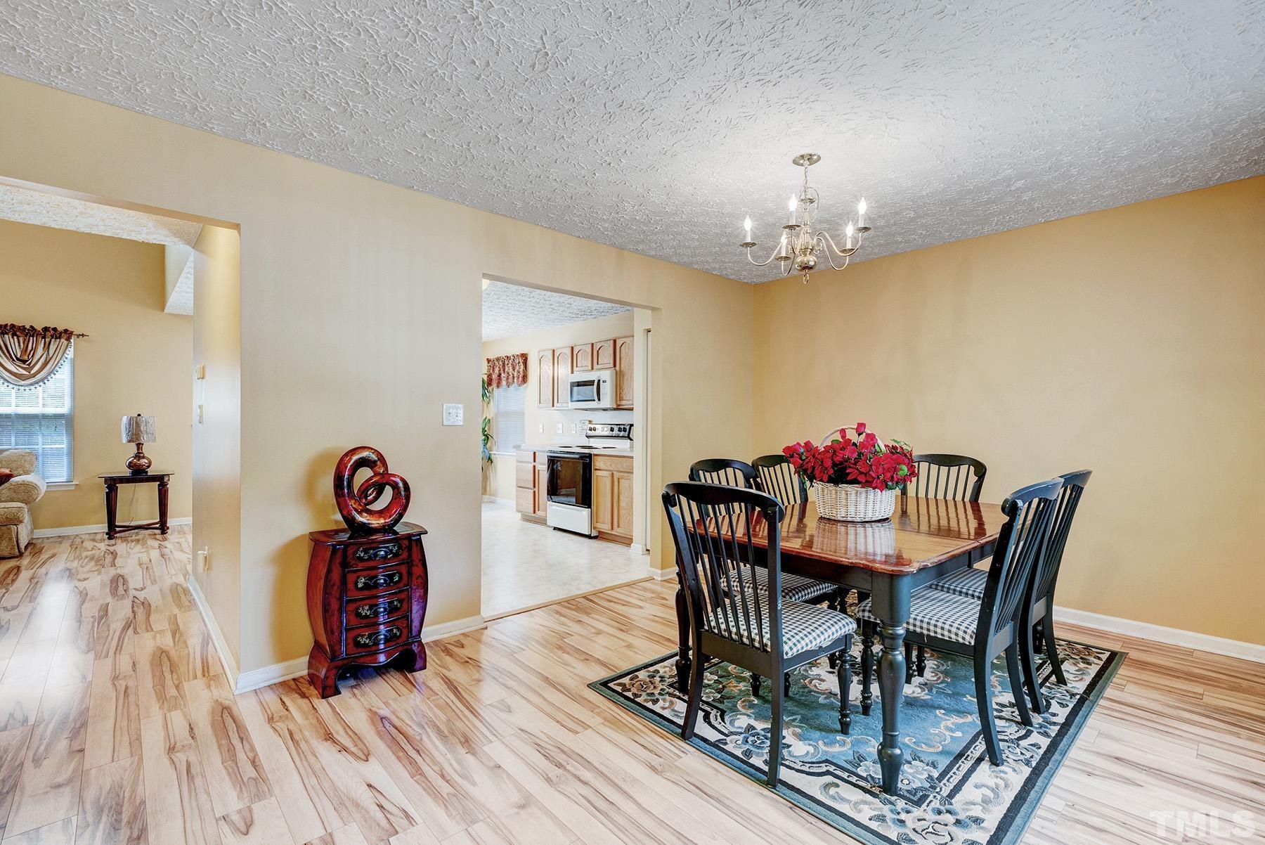 5712 Forest Point Road Raleigh, NC 27610 - Photo 6 of 23 a view of a dining room with furniture and wooden floor