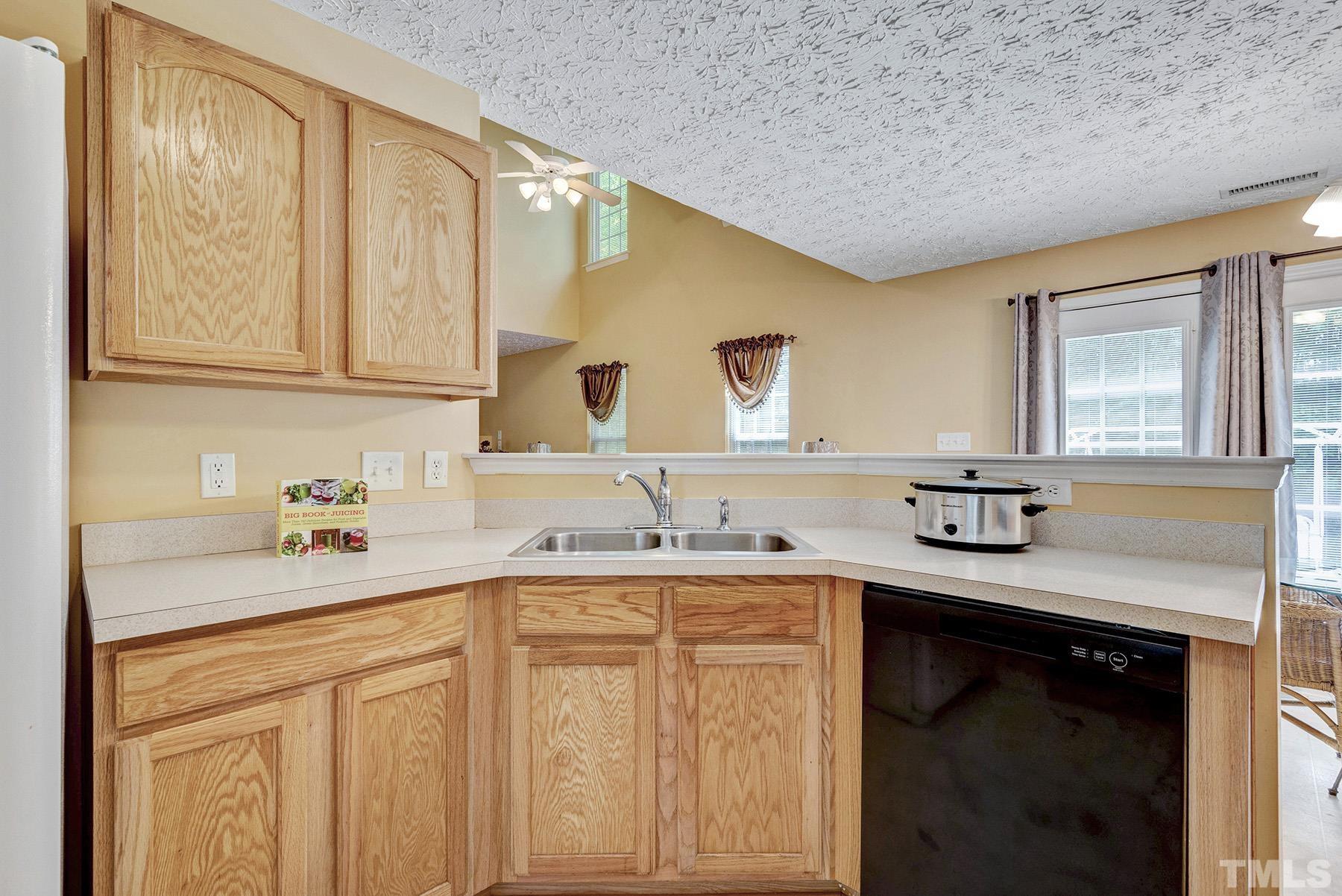5712 Forest Point Road Raleigh, NC 27610 - Photo 10 of 23 a kitchen with a sink cabinets and window