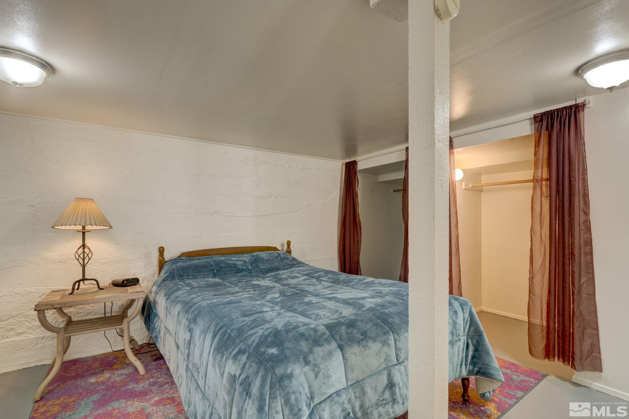 1102 Codel Way Reno, NV 89503 - Photo 25 of 33 a bedroom with a bed and a chandelier