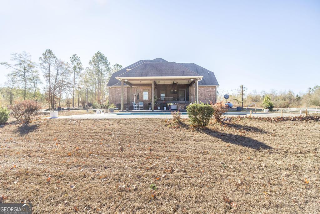 4065 Gordon Road Abbeville, GA 31001 - Photo 38 of 48 a front view of a house with a yard and trees