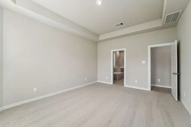 a view of an empty room and closet area