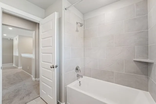 a bathroom with a bathtub and shower