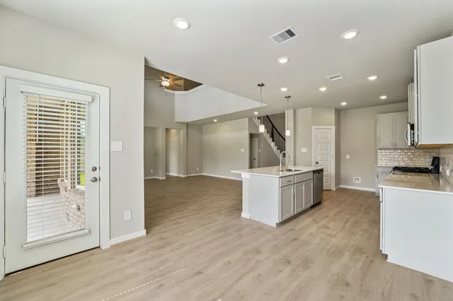 a view of kitchen with cabinets and wooden floor