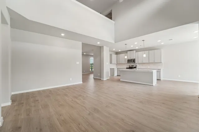 a view of a kitchen with a sink and a refrigerator