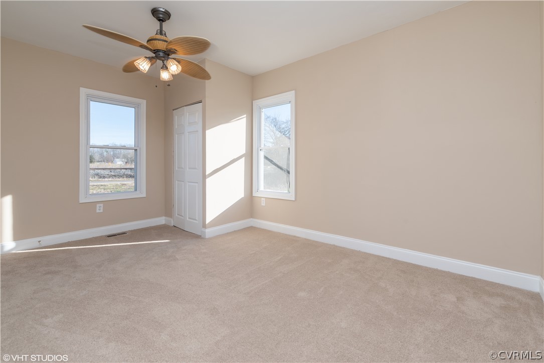 8329 Peaks Road Hanover, VA 23069 - Photo 13 of 25 an empty room with windows and chandelier fan
