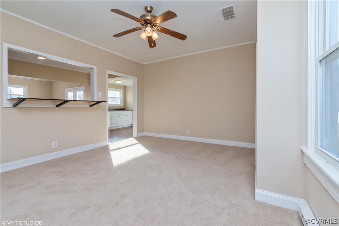 8329 Peaks Road Hanover, VA 23069 - Photo 5 of 25 an empty room with a chandelier fan and windows