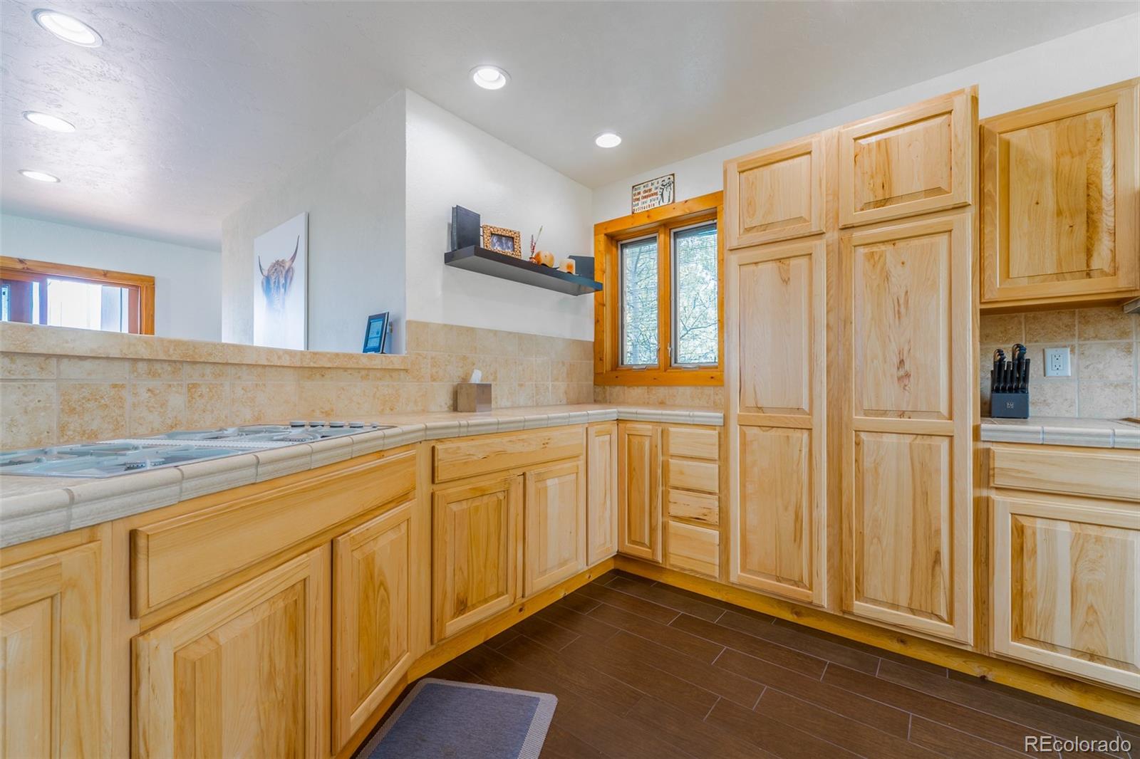 8221 Remington Road Como, CO 80432 - Photo 20 of 49 a kitchen with granite countertop white cabinets and white appliances
