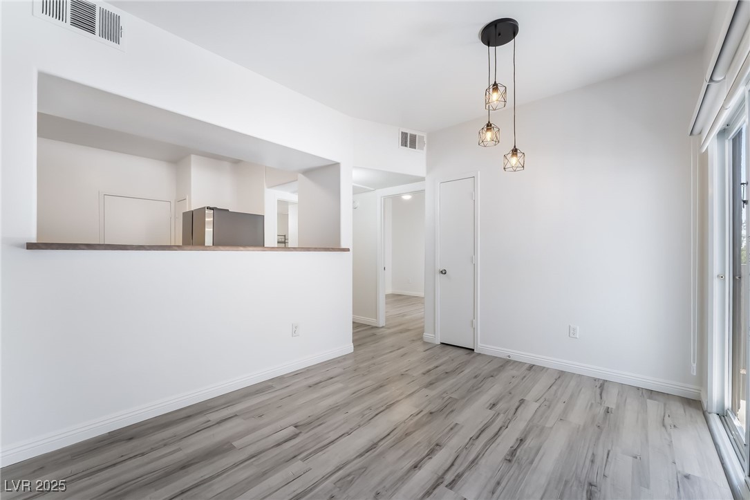 7255 West Sunset Road, Unit 1148 Las Vegas, NV 89113 - Photo 10 of 62 Spare room featuring wood finished floors and baseboards